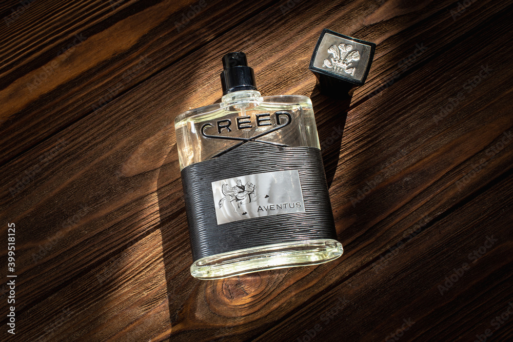 Creed Aventus 120 ml eau de parfum bottle on a wooden table surface Stock  Photo | Adobe Stock