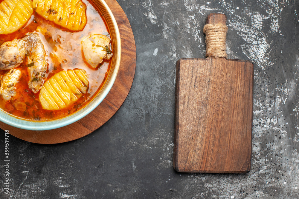 Chicken soup on round cutting board and chopper board