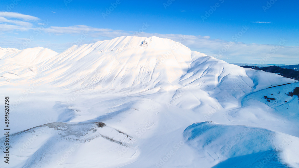Plain of Castelluccio di Norcia and Monte Vettore. Landscape covered with white snow seen from drone. uncontaminated landscape, the silence of nature
Plain of Castelluccio di Norcia and Monte Vettore. Landscape covered with white snow seen from drone. uncontaminated landscape, the silence of nature
