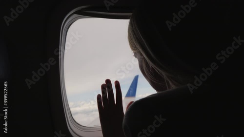 Wallpaper Mural Silhouette of a woman looking out the window of the plane. Back view Torontodigital.ca
