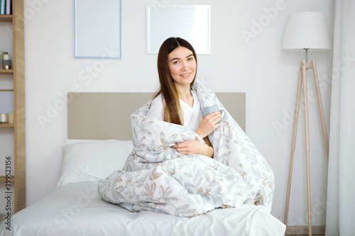 Beautiful young girl in a good mood in pajamas in the bedroom © White bear studio 