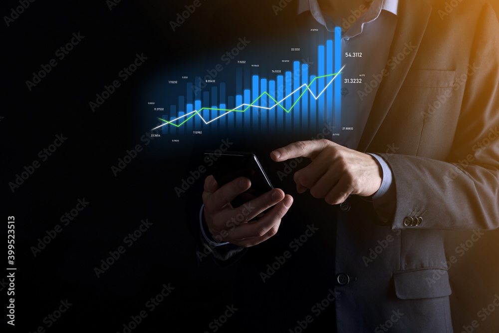 Business man holding holographic graphs and stock market statistics gain profits. Concept of growth planning and business strategy. Display of good economy form digital screen. Business man holding holographic graphs and stock market statistics gain profits. Concept of growth planning and business strategy. Display of good economy form digital screen.