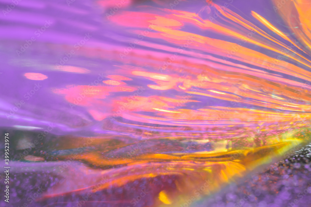 Abstract iridescent amethyst lilac and yellow fluid liquids reflections background with lens flare soft focus. Trending gradient illuminating colors festive background for greeting card or blog