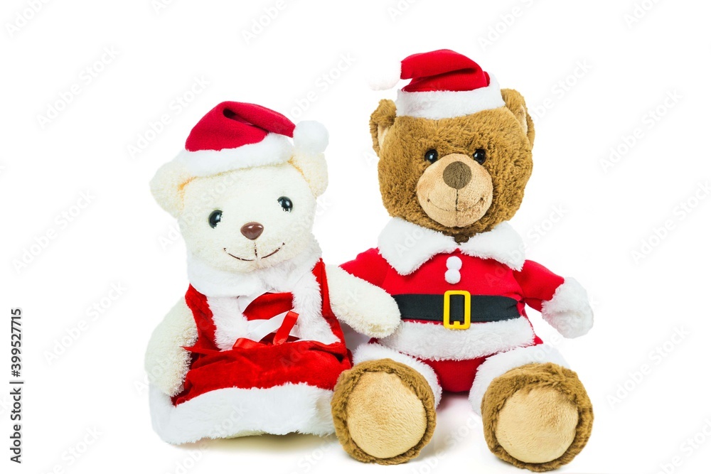 Couple teddy bear doll wearing santa set sitting isolated on white background,Christmas day and New Year's gifts Couple teddy bear doll wearing santa set sitting isolated on white background,Christmas day and New Year's gifts