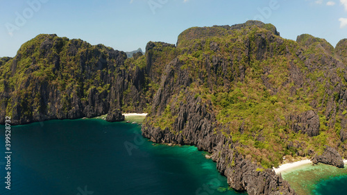 aerial view tropical lagoon with sandy beach surrounded by cliffs. El nido, Philippines, Palawan. beautiful lagoon and karst scenery.