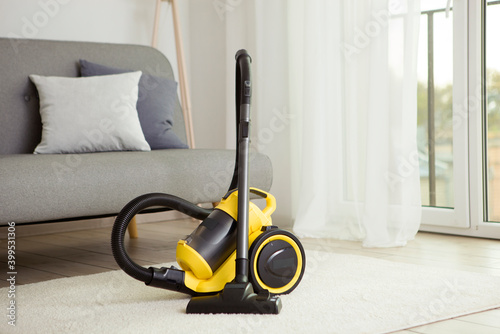Vacuum cleaner yellow in the interior of the room