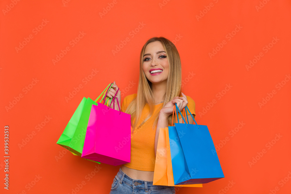 Smiling Young Woman With Colorful Shopping Bags