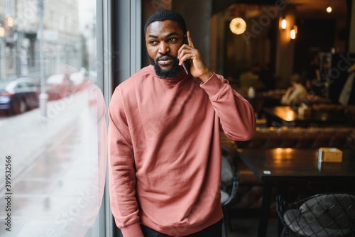 Portrait young black businessman talking on mobile phone