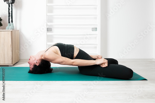 Yoga instructor doing yoga at her home