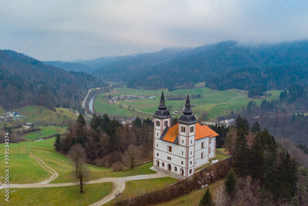 Cold late autumn panorama of Saint Volbenk church in the Poljanska valley close to Skofja Loka in Slovenia.
