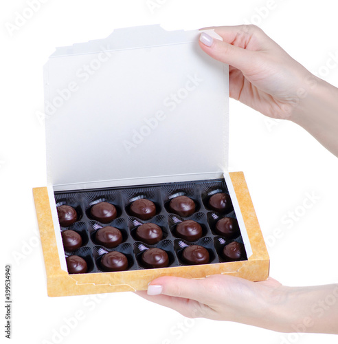 Box of candies in hand on white background isolation