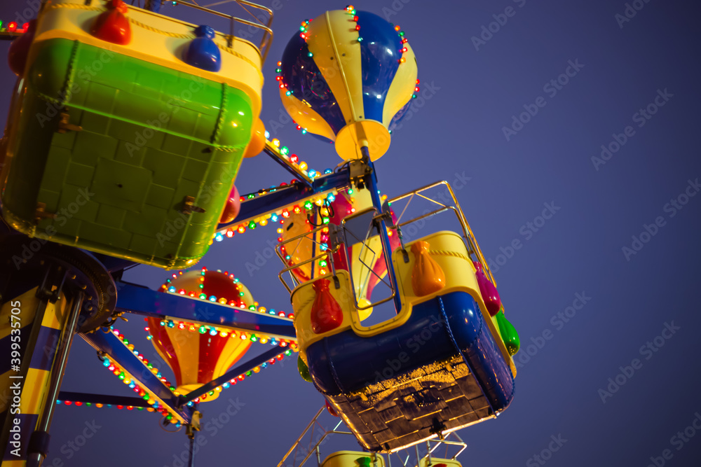 Fototapeta premium Upper part of vintage carousel. Evening time, outdoor. Holiday, travel, leisure, carnival and entertainment concept
