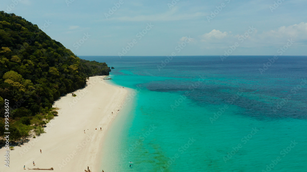 Coast with sandy beach with tourists and clear blue sea top view, Puka shell beach. Boracay, Philippines. Seascape with beach on tropical island. Summer and travel vacation concept.