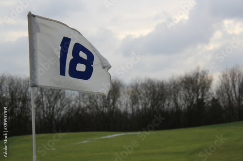 flag of whoöe 18 on a golf course photo