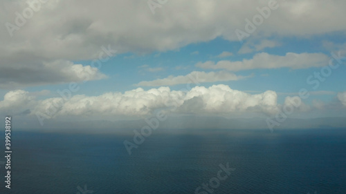 Seascape in cloudy weather, aerial view. Water cloud horizon background. Blue sea water with small waves against sky.