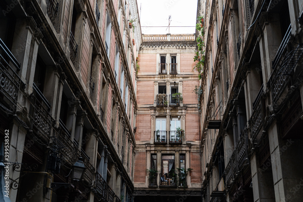 Old historic houses with windows, balconies and streetlight in Barcelona