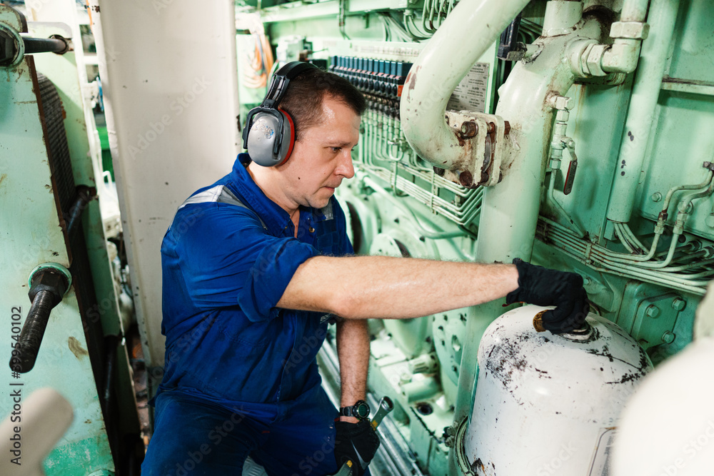 Marine engineer officer controlling vessel engines and propulsion in