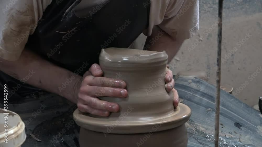 Forming a jug on a wheel in the pottery production of tableware. Forming a jug on a wheel in the pottery production of tableware.