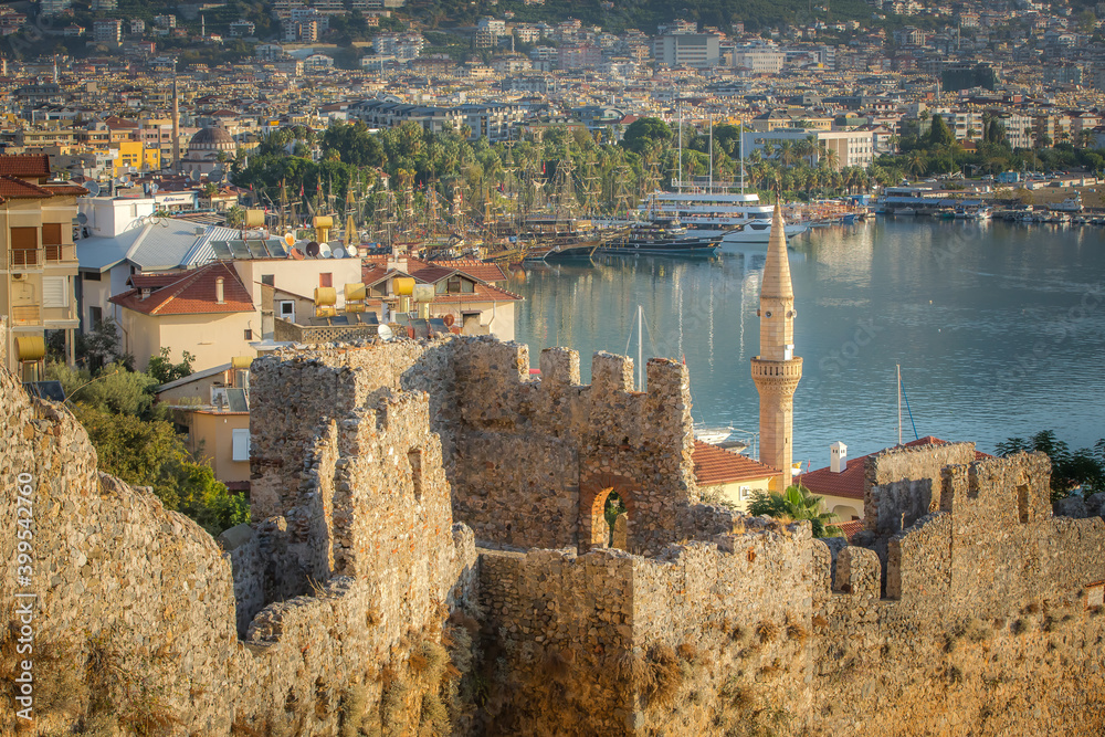 Morning view of the beautiful old town of Alanya, its fortress, towers, port, mosques and minarets from the walls of the medieval castle.