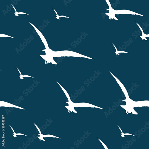 Flying seagulls silhouettes over deep blue background seamless pattern. Minimal. Simple.