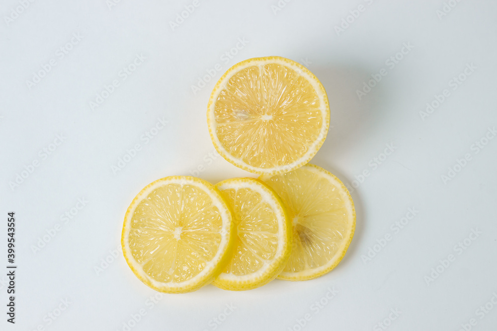 Lemons on a white background. Citrus fruit. Healthy food. Sliced lemon. Sour fruit
