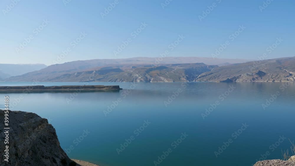 Beautiful calm lake in the mountains under a clear sky. Beautiful calm lake in the mountains under a clear sky.