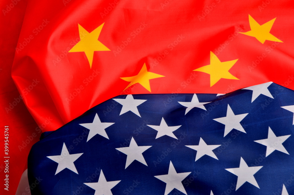 United States of America flag and China flag together. American and china flag close-up. United States of America flag and China flag together. American and china flag close-up.