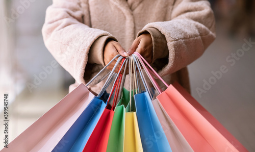 Closeup of black woman showing shopping bags