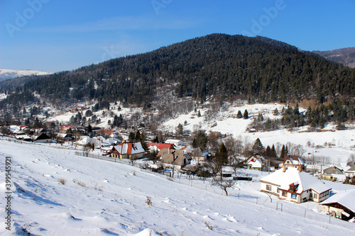 Winter village with mountain scene © Karol