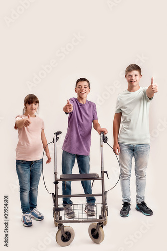 Obraz na plátně Full length shot of three disabled children with Down syndrome and cerebral pals