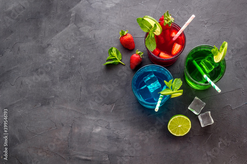 Set of different drinks cocktails with ice - red blue and green. Top view photo