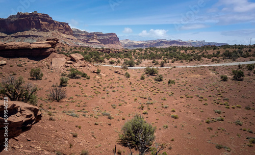 Amazing sandstone monoliths in a barren desert prairie on a blue partly cloudy summer day at Capitol Reef National Park in Torrey Utah photo