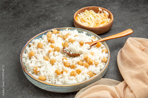 Quick and easy peas and rice meal for dinner with a spoon and sauerkraut on dark background photo