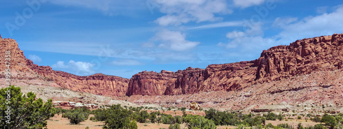 Amazing sandstone monoliths in a barren desert prairie on a blue partly cloudy summer day at Capitol Reef National Park in Torrey Utah © Marc Sanchez