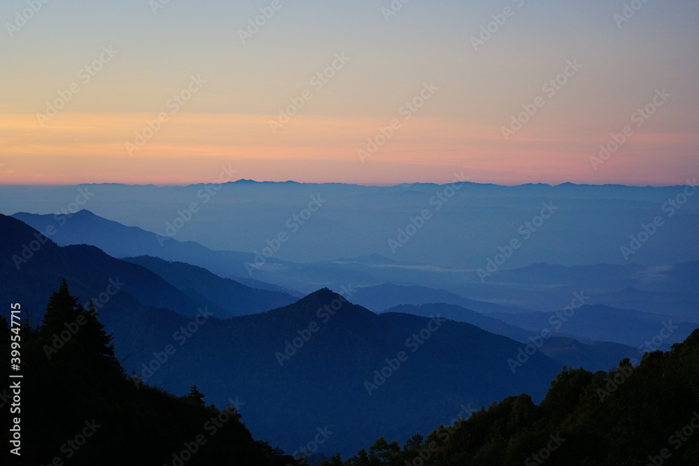 The National park mountain view landscape with foggy in morning sunrise beautiful orange sky background The National park mountain view landscape with foggy in morning sunrise beautiful orange sky background