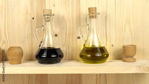 Wallpaper Mural Glass bottles with vegetable oil and wooden bowls stand on a wooden shelf in the kitchen Torontodigital.ca