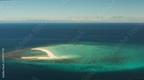 Beautiful beach on tropical island surrounded by coral reef, sandy bar with tourists, top view. Sandbar Atoll. Summer and travel vacation concept, Camiguin, Philippines.