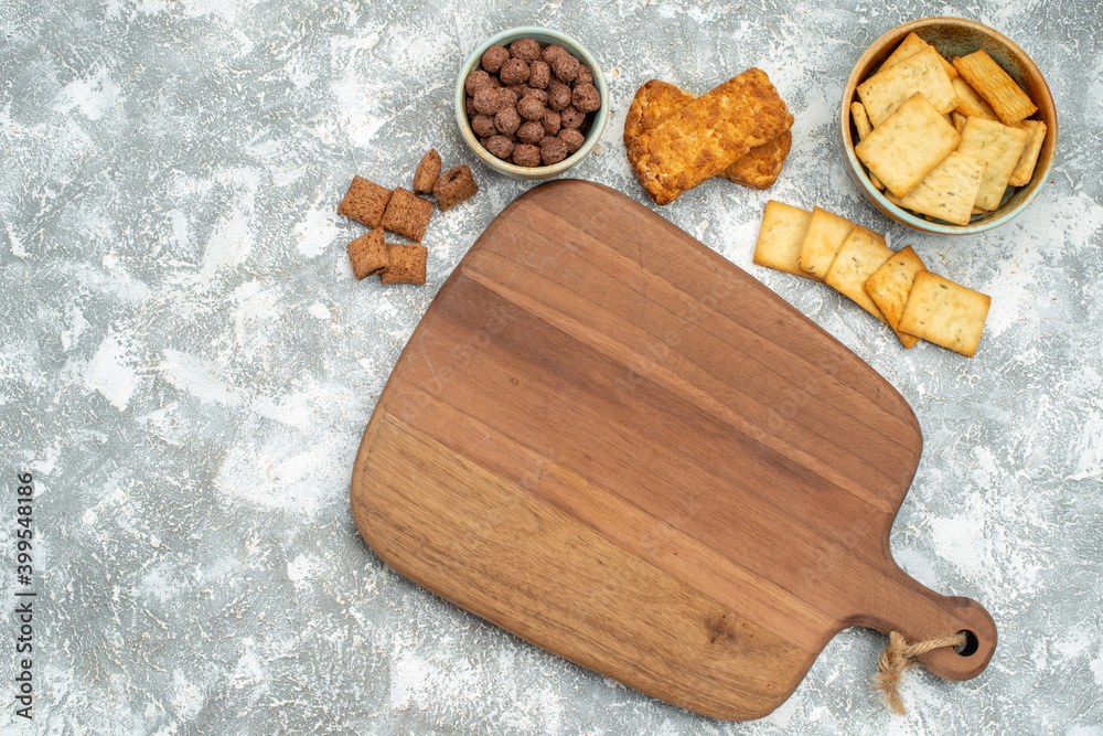 Close up view of various cookies with biscuits and cutting board on blue backgound