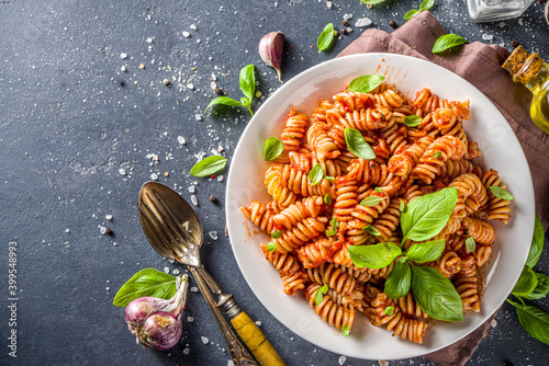 Bild auf Leinwand Fusilli pasta with tomato sauce and basil