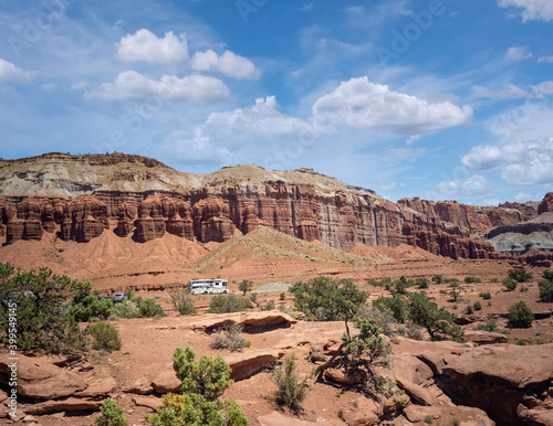 Amazing sandstone monoliths in a barren desert prairie on a blue partly cloudy summer day at Capitol Reef National Park in Torrey Utah