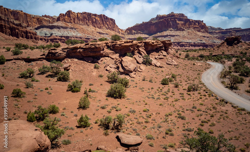 Amazing sandstone monoliths in a barren desert prairie on a blue partly cloudy summer day at Capitol Reef National Park in Torrey Utah photo