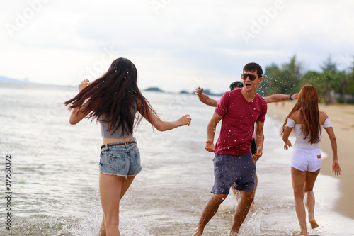 Group of friends having fun walking relaxing on the beach.Holiday and vacation concepts.