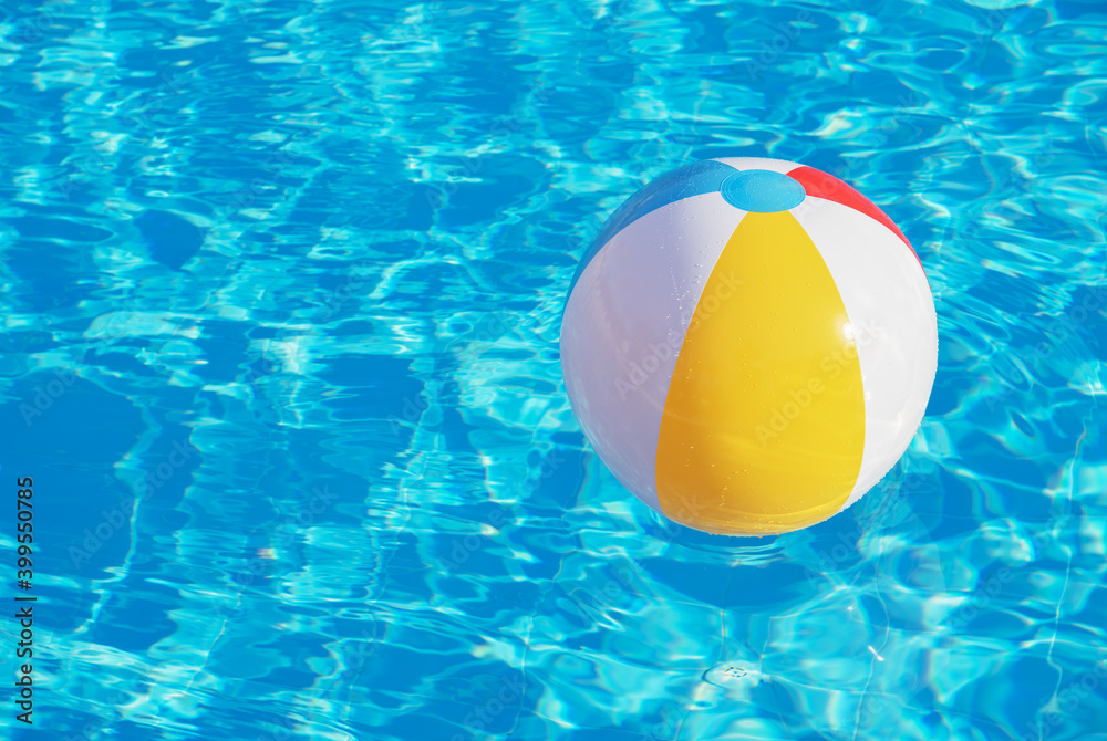 Colorful inflatable ball floating in swimming pool