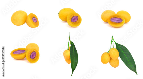 Fototapeta Naklejka Na Ścianę i Meble -  Plum Marian Set , Thai fruit is called Maprang or Mayongchid, cut in half, yellow orange, ripe, shadowed and without shadow, with green leaves. With purple seeds Isolated on a white background