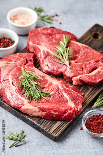 Two Fresh Raw meat Prime Black Angus Beef Steaks, Rib Eye, Denver, on wooden cutting board