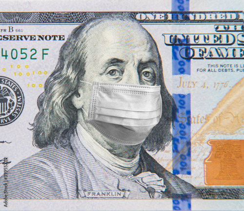 Benjamin Franklin in a mask on a 100 dollar bill isolated on white background. Concept of prevention of money from crisis.