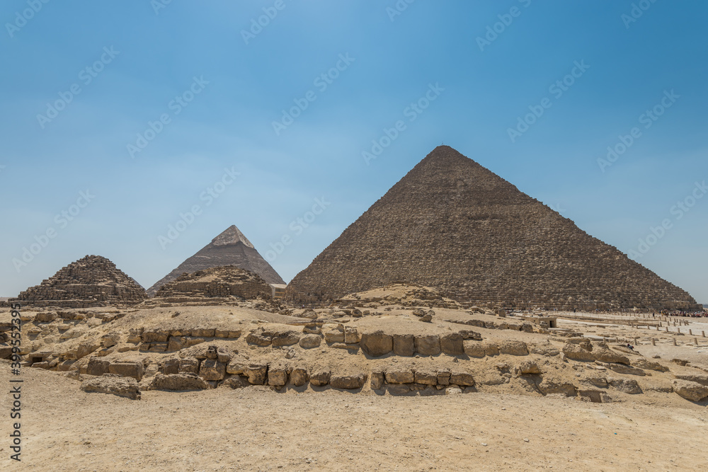 The Giza pyramid complex, an archaeological site on the Giza Plateau, on the outskirts of Cairo, Egypt. It includes the three Great Pyramids : Khufu Cheops, Khafre Chephren and Menkaure. The Giza pyramid complex, an archaeological site on the Giza Plateau, on the outskirts of Cairo, Egypt. It includes the three Great Pyramids : Khufu Cheops, Khafre Chephren and Menkaure.