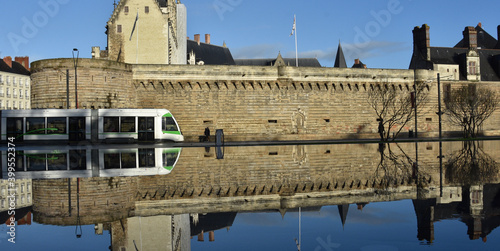 Passage du Tramway a Nantes en reflet dans le miroir d'eau. avec Château des ducs de Bretagne. France photo