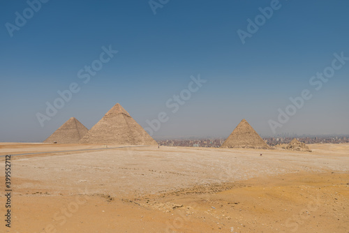 The Giza pyramid complex  an archaeological site on the Giza Plateau  on the outskirts of Cairo  Egypt. It includes the three Great Pyramids   Khufu Cheops  Khafre Chephren and Menkaure.