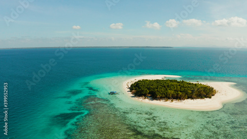 Fototapeta Naklejka Na Ścianę i Meble -  Tropical island with sandy beach by atoll with coral reef and blue sea, aerial view. Patawan island with sandy beach. Summer and travel vacation concept.